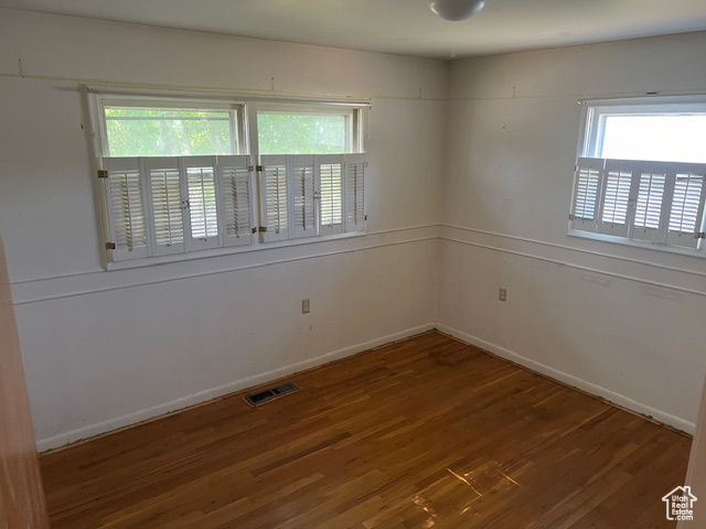 Empty room featuring hardwood / wood-style flooring