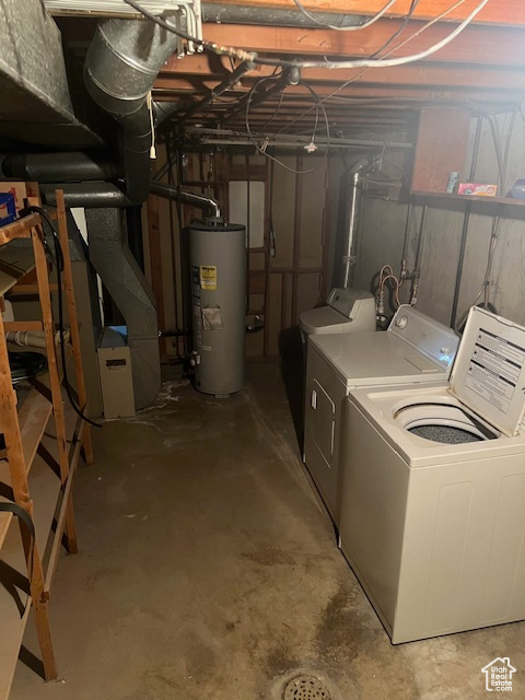 Basement featuring water heater and washing machine and dryer