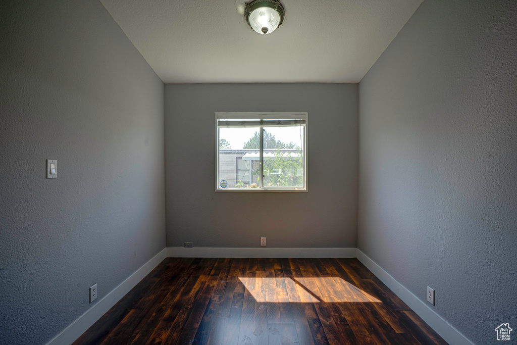 Spare room with dark hardwood / wood-style flooring