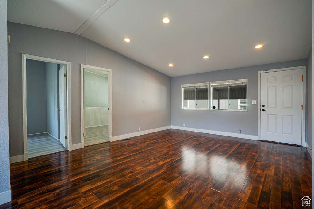 Interior space with vaulted ceiling and hardwood / wood-style floors