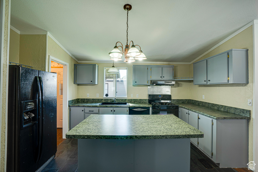 Kitchen featuring black appliances, an inviting chandelier, sink, dark hardwood / wood-style floors, and ornamental molding