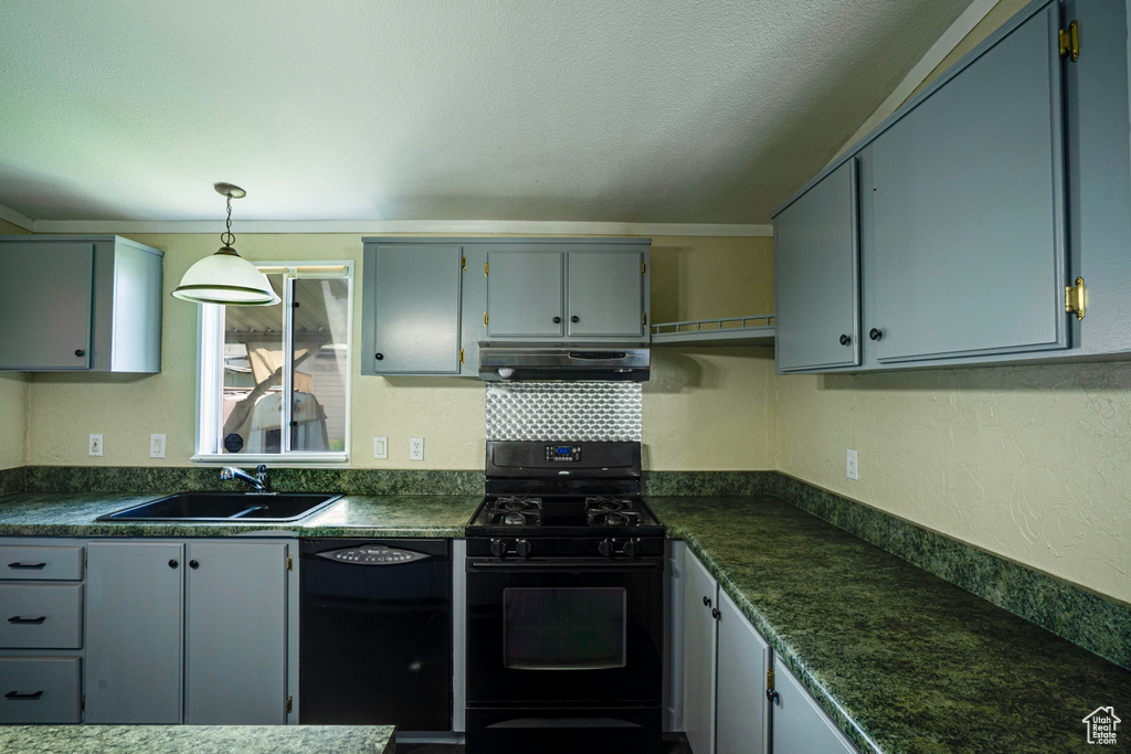 Kitchen with gray cabinets, pendant lighting, black appliances, and sink