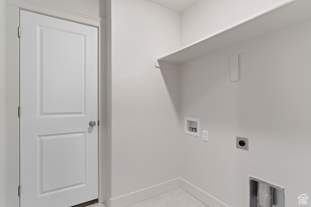 Laundry room featuring light tile patterned flooring, hookup for an electric dryer, and washer hookup