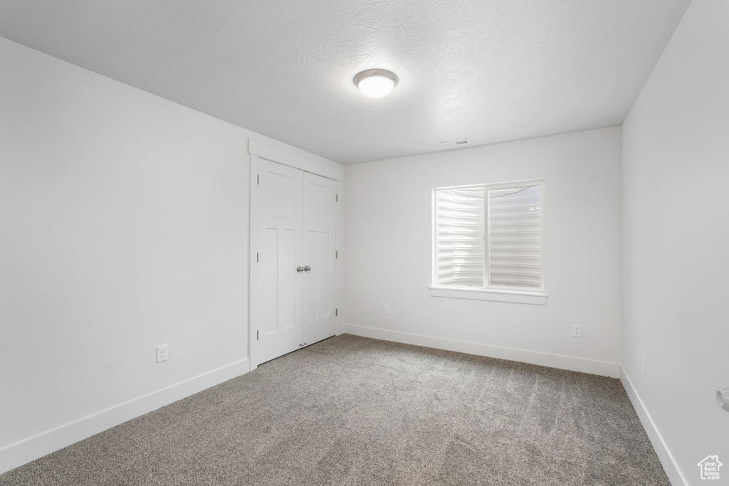 Unfurnished room with carpet floors