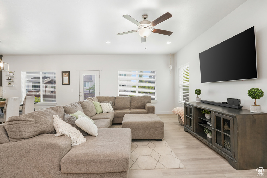 Living room featuring ceiling fan and light wood-type flooring