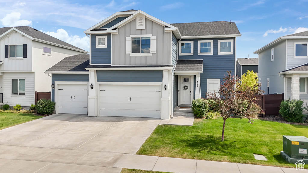 View of front facade with a garage and a front yard