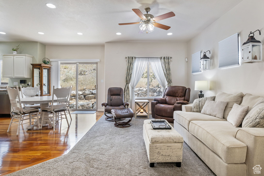 Living room featuring a wealth of natural light, ceiling fan, and light hardwood / wood-style floors