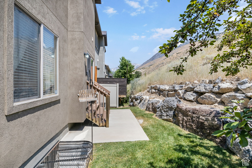 View of yard featuring a mountain view and a patio