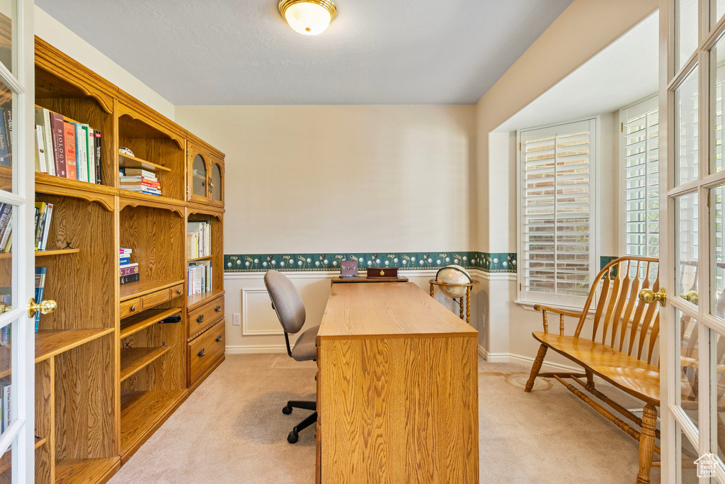 Office area with french doors and light colored carpet