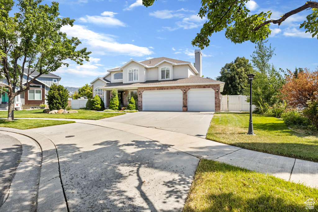 Front facade with a garage and a front lawn