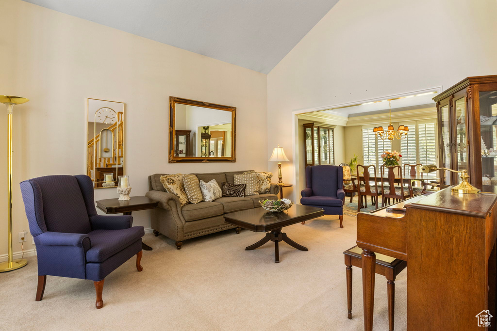 Carpeted living room featuring high vaulted ceiling