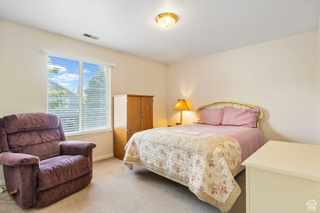 Bedroom with light colored carpet