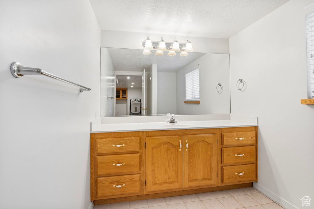 Bathroom with tile patterned flooring and vanity