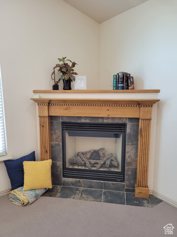 Room details featuring a tiled fireplace