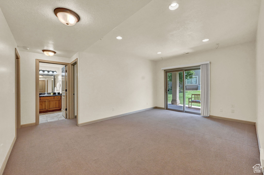 Unfurnished room featuring light carpet