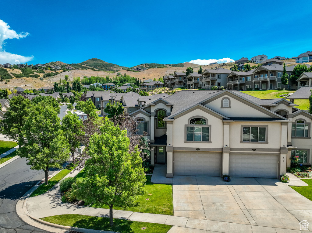 View of front of home featuring a mountain view and a garage