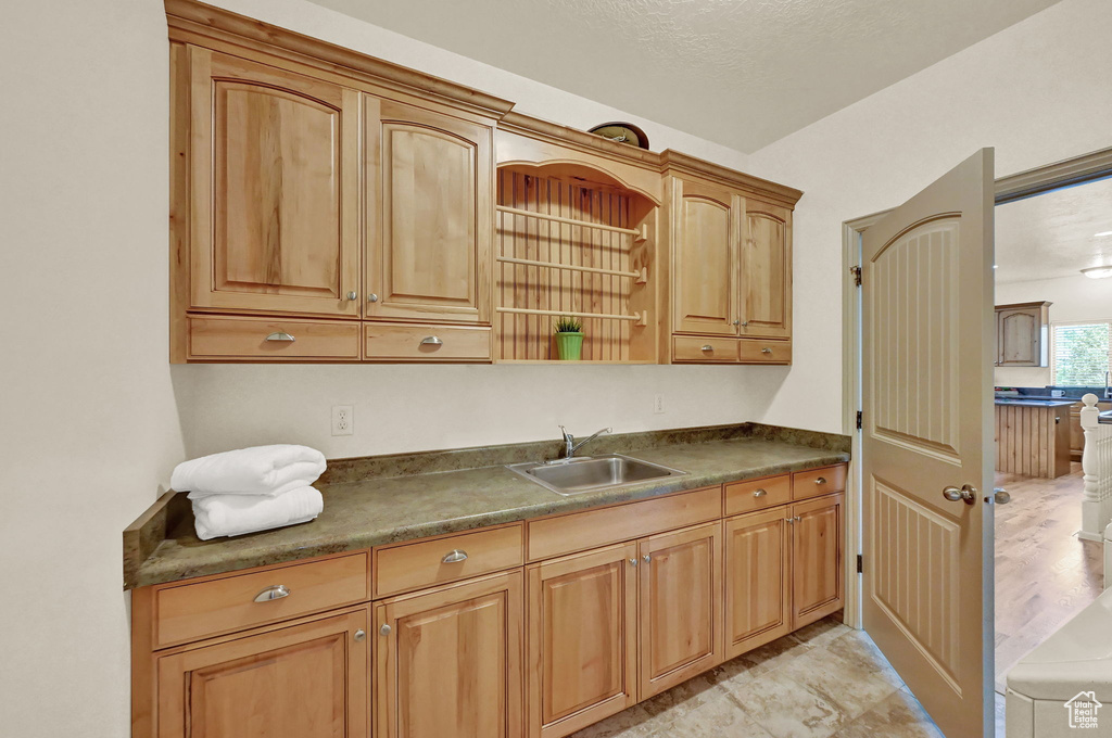 Kitchen with sink and light hardwood / wood-style flooring