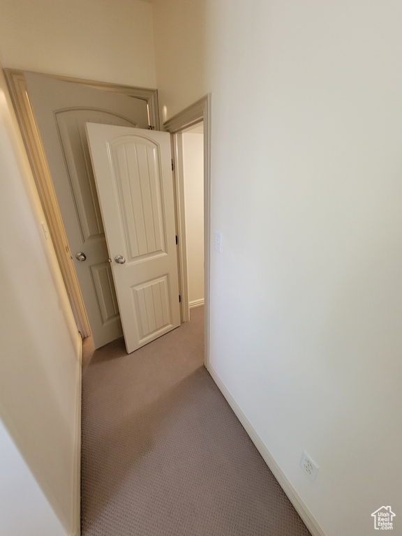 Corridor with light colored carpet