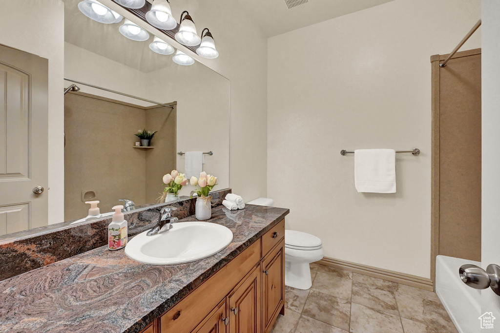 Full bathroom with shower / bathtub combination, vanity, tile patterned flooring, and toilet