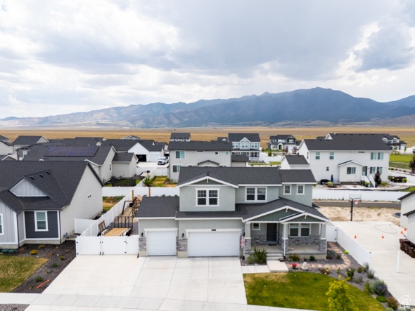 View of front facade with a mountain view and a garage