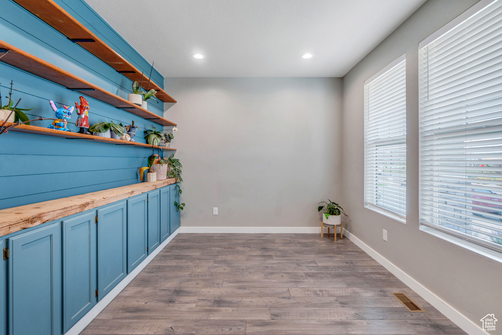 Bar featuring wood counters, blue cabinetry, and dark hardwood / wood-style floors