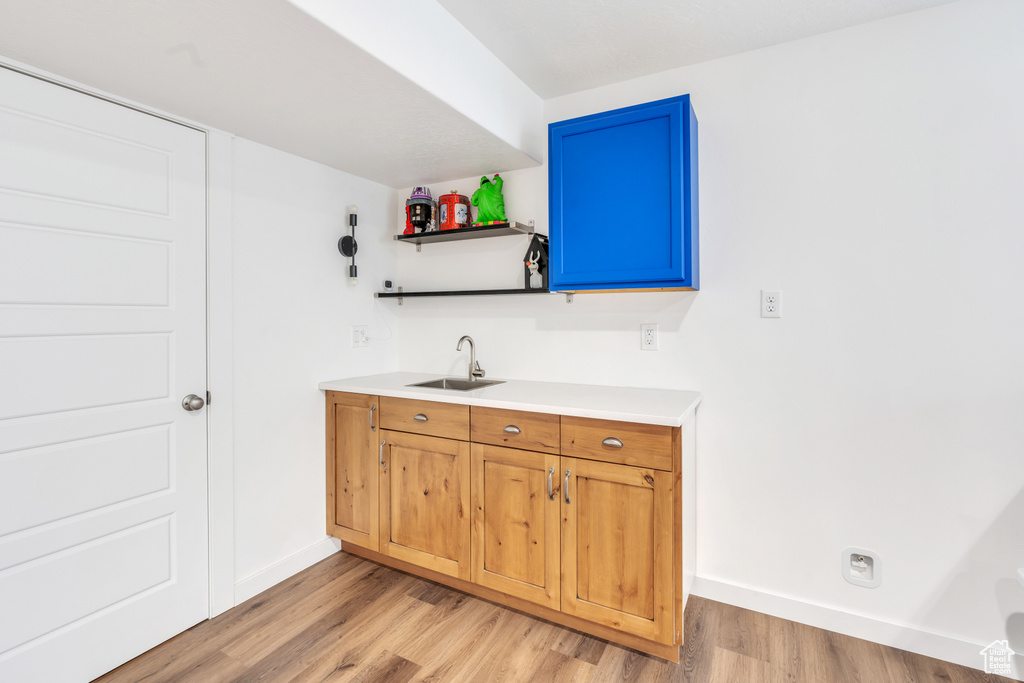 Interior space with light hardwood / wood-style floors and sink