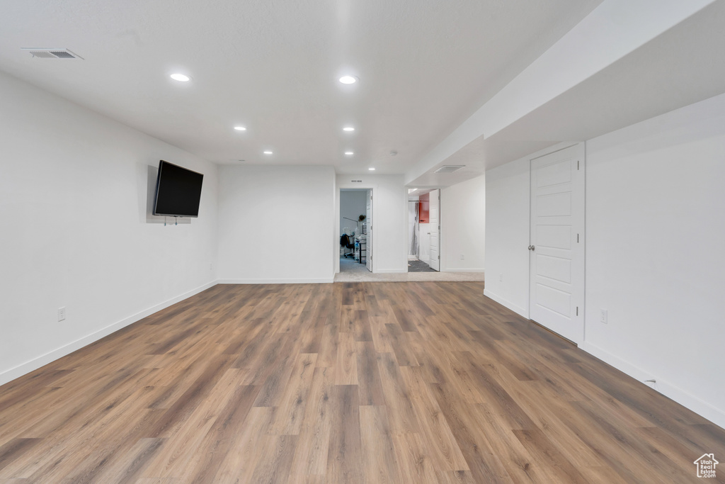 Basement with hardwood / wood-style floors