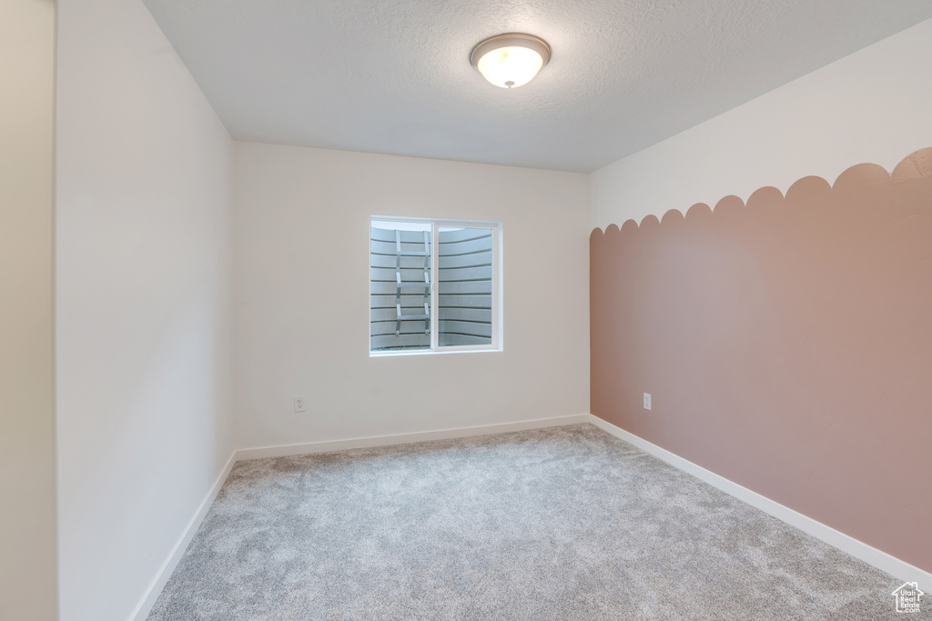 Spare room featuring carpet flooring