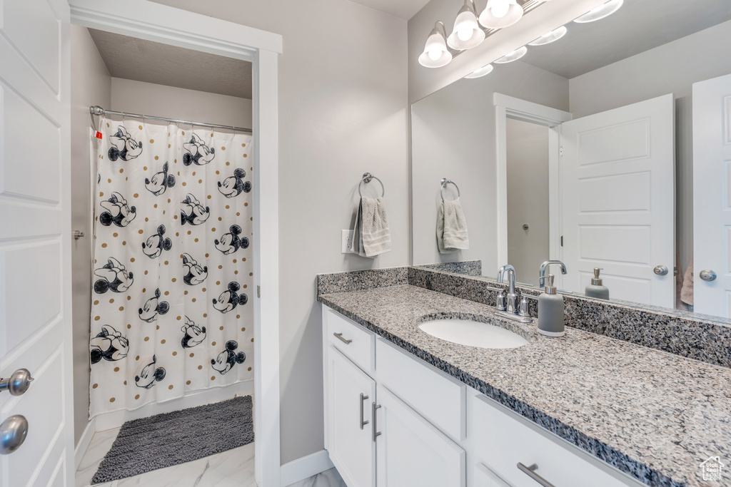 Bathroom with vanity and tile patterned flooring