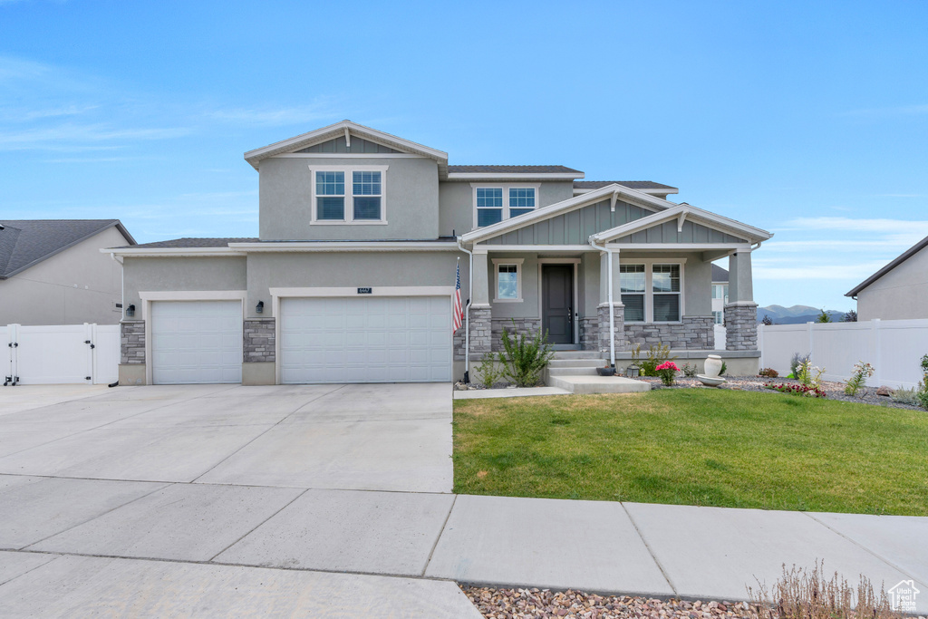 View of front of home featuring a garage and a front yard