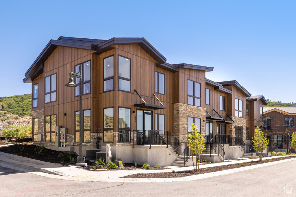 View of front of property featuring central AC unit