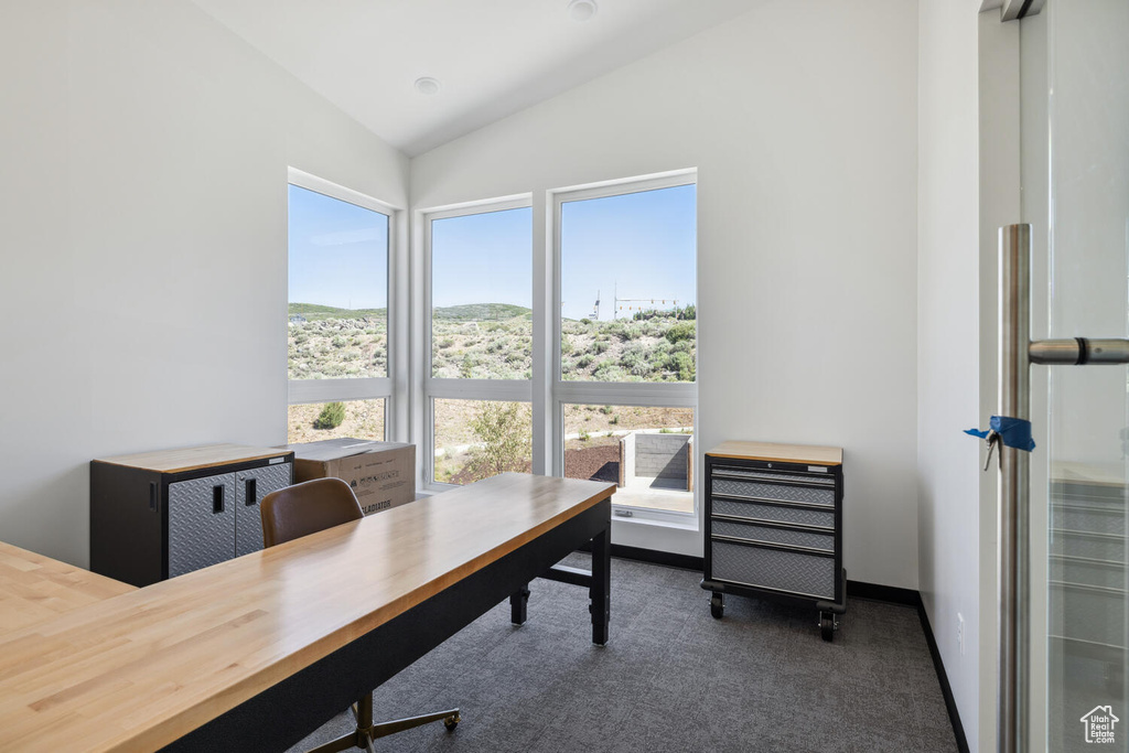 Carpeted office with vaulted ceiling