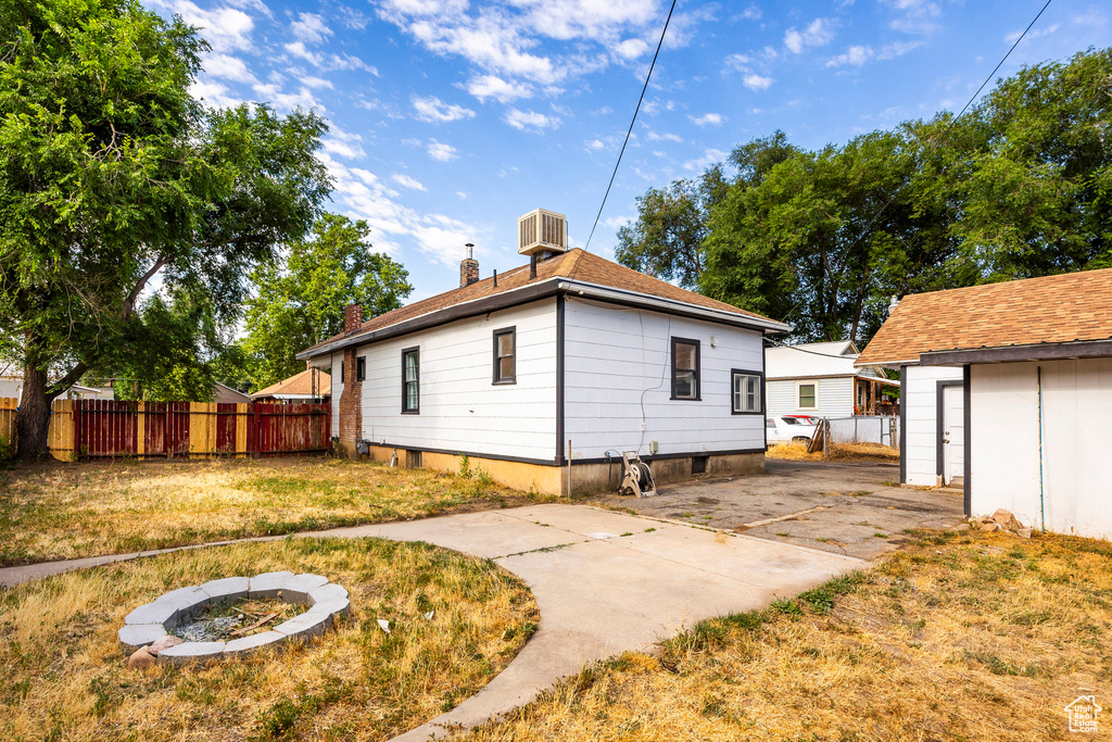 Back of property with a patio area and a lawn