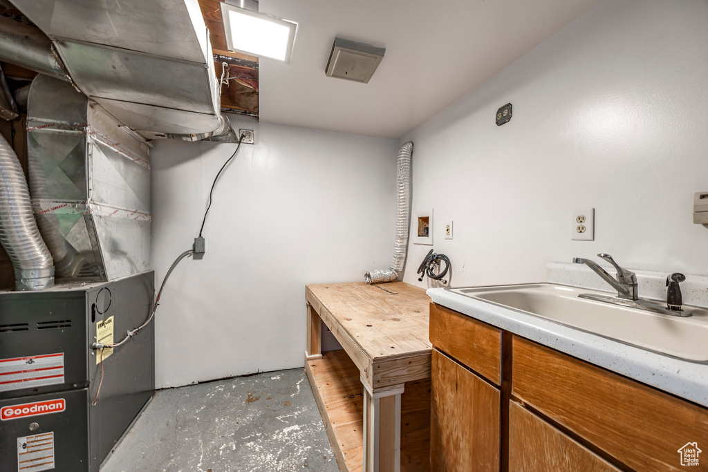 Washroom featuring sink, cabinets, hookup for a washing machine, and light wood-type flooring