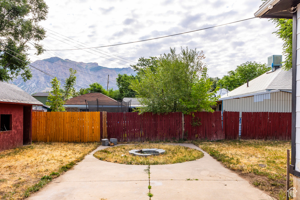 View of yard featuring a mountain view, cooling unit, and a patio