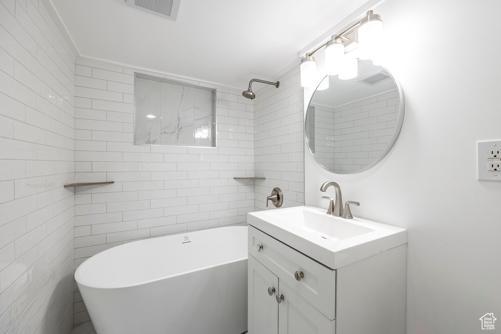 Bathroom with tile walls and vanity