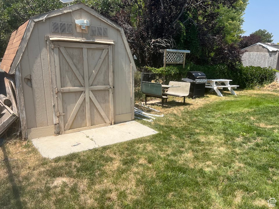 View of outdoor structure with a lawn