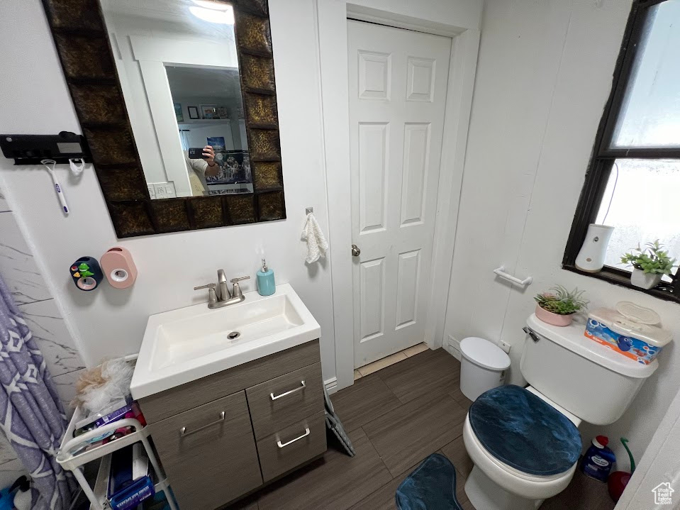 Bathroom featuring tile patterned floors, toilet, and vanity