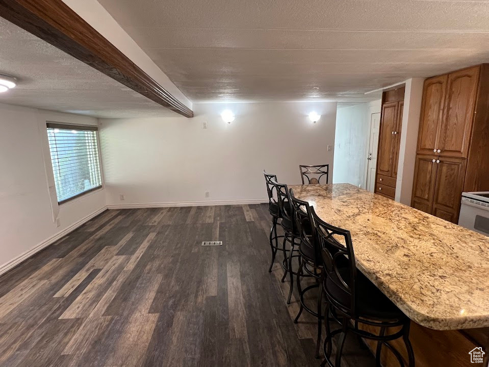 Dining room featuring a textured ceiling and dark hardwood / wood-style floors