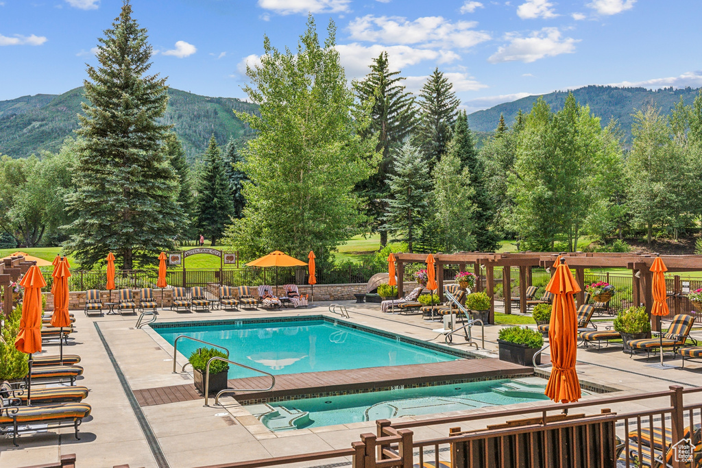 View of pool featuring a mountain view and a patio area