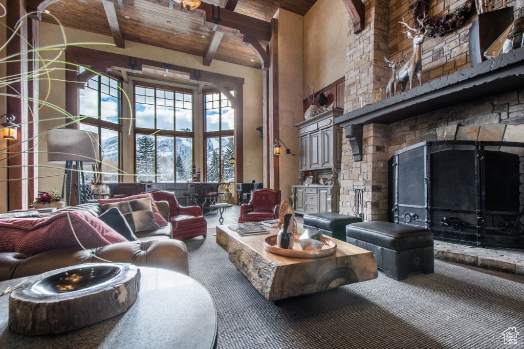 Living room with beamed ceiling, a towering ceiling, and wood ceiling