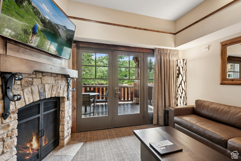 Living room with a fireplace, french doors, and carpet floors