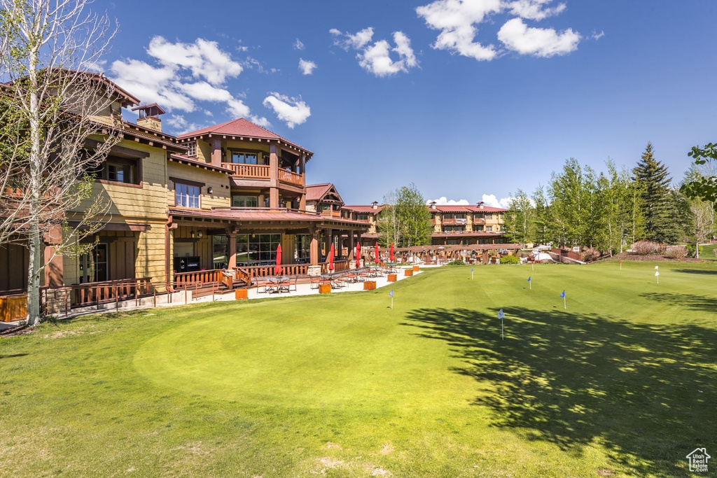 View of yard with a balcony