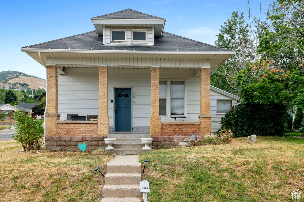 Bungalow-style house featuring a front lawn