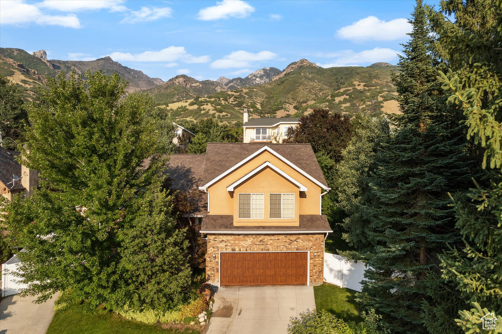 View of front of home featuring a garage and a mountain view