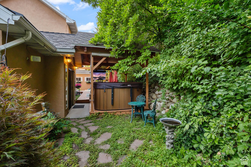 View of yard with a patio and a hot tub