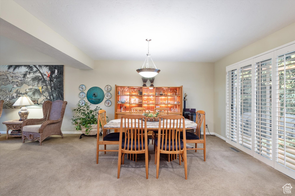 Dining room with light colored carpet