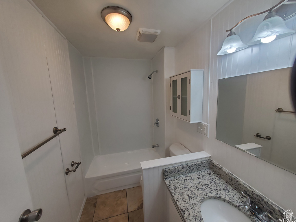 Full bathroom featuring tile patterned floors, bathing tub / shower combination, toilet, and vanity