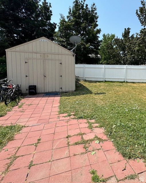 View of outdoor structure with a lawn