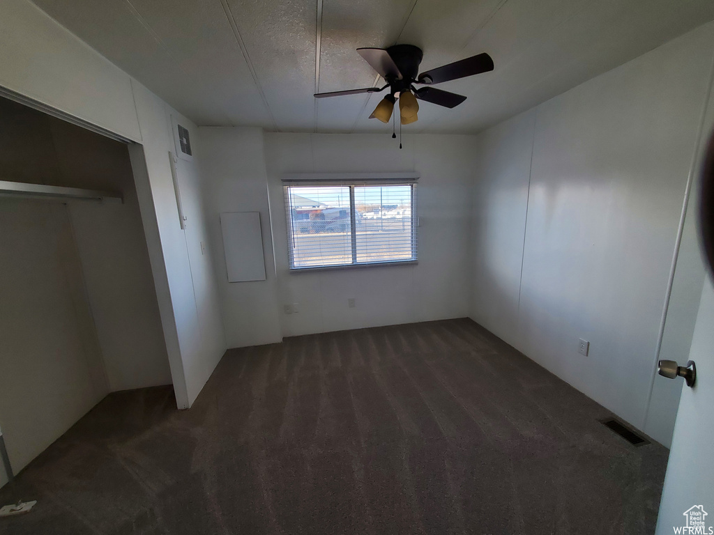 Unfurnished bedroom featuring carpet, a closet, and ceiling fan